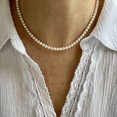 "This classic necklace is made from high quality genuine AAA grade 5mm round white cultured fine freshwater pearls with a high luster. A delicate, feminine & classy necklace perfect for all occasions and bridal too. These pearls have a rich luster, are perfectly calibrated, and are uniform in size.  Pearls have an international grading scale, these beautiful pearls are graded as follows: surface: AAA luster: AAA round: AA+ - Photos taken outside in natural lighting and in a light box.  - No filt Classic Pearl White Pearl Necklace As Gift, Classic Pearl Necklace With Round Beads, Classic Pearl Necklace With Round Beads As Gift, Classic Pearl Necklace As A Gift, Classic Pearl Necklace Gift, Classic Single Strand Pearl Necklace Gift, Classic Single Strand Pearl Necklace As Gift, Classic Akoya Pearl Necklace As Gift, White Single Strand Pearl Necklace For Anniversary