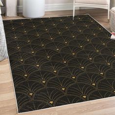 a black and gold rug with an art deco design on the floor in a living room