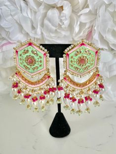 "Mint Green Meenakari Earrings and Tikka Set If you're looking for a jewelry set to wear to an upcoming Indian event, look no further - with handpainted details and pearl accents, this traditional mint green meenakari earring and tikka set has our heart!  These earrings are perfect for Indian weddings and festivities (I would wear these to a sangeet party). These also make for a pretty & memorable gift for special occasions! Details: 1 pair of hand-painted meenakari earrings 1 matching tikka  Shop more of our Indian Earrings here: https://www.etsy.com/shop/jazzyandco?section_id=23690892 What is Meenakari? Meenakari is a Persian art of colouring the surface of metals by fusing brilliant colours. The art was brought to India by Persian enamellists around the early 17th century. Mina is the f Luxury Meenakari Party Sets, Cheap Meenakari Jewelry For Festive Occasions, Affordable Meenakari Jewelry For Festive Season, Cheap Traditional Meenakari Earrings, Festive Meenakari Jewelry, Luxury Designer Meenakari Jewelry, White Meenakari Fusion Jhumkas, Fusion Style White Bridal Earrings With Meenakari, Green Meenakari Chandelier Earrings For Diwali