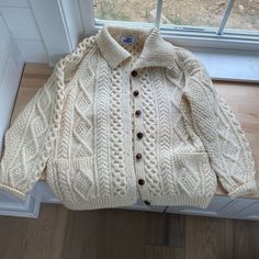 Cream Color Fisherman Cable-Knit Button-Down Cardigan Sweater With Collar And Front Patch Pockets. Raglan Sleeves. Thick, Heavyweight, And Very Warm. Pure New Wool, Itchy Material. It’s Unused And In Pristine Condition. Has A Slight Vintage Odor Due To Its Age. One Size - Could Fit Up To An Xxl - Please Check Measurements Below To Determine Fit. Approx Flat- Pit To Pit 24” Length 27.5” Sleeve Length 30” Classic White Sweater With Buttons, Sweater With Collar, Christmas Sweater Vest, Drop Shoulder Cardigan, Sweater Duster, Chunky Knit Cardigan, Levi Jeans 501, Collar Sweater, Cardigan Top