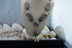 "This is the perfect option for those who like cool, unique jewelry and the luxury, shine of silver, brown. This necklace is well made, cute and/or elegant in design, and very desirable. Its style is a Sautoir, with its beautiful Petrified Wood stones and 4 dangles of genuine champagne pearls hanging 2-1/2 inches from a square bronze glass bead. See all our pictures. Going up each side of the main necklace are brownstones with lots of matrices. They are expertly matched on each side, on sterling Silver Beaded Dangle Necklaces As Gift, Dangle Silver Beaded Necklaces As Gift, Silver Beaded Dangle Necklaces For Gifts, Silver Bead Dangle Necklaces For Gifts, Dangle Silver Beads Necklace For Gift, Unique Sterling Silver Jewelry With Polished Beads, Amber Jewelry With Silver Beads For Gift, Amber Jewelry With Silver Beads As A Gift, Elegant Brown Sterling Silver Necklace