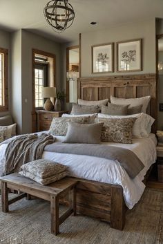 a large bed sitting in a bedroom next to two windows and a wooden headboard