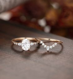 two gold rings with white diamonds on them