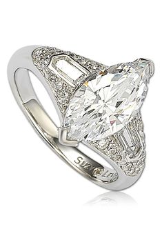 - Sterling silver white marquise cut CZ center gemstone with round CZ accents ring . Approx. 15mm L x 18mm W ring face. Imported Sterling silver, cubic zirconia Luxury Marquise Cubic Zirconia Diamond Ring, Luxury Cubic Zirconia Marquise Diamond Ring, Diamond White Rings With Accent Stones, Dazzling Platinum Diamond Ring With Accent Stones, Luxury Baguette Cut Diamond Ring With Accent Stones, Marquise Cubic Zirconia Ring With Diamond Cut, Baguette Cut Diamond Ring With Accent Stones, Fine Jewelry Marquise Diamond Ring With Accent Stones, White Gold Cubic Zirconia Ring, Marquise Cut