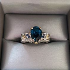 a ring with a blue stone in it