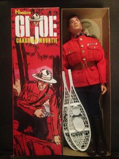 an action figure in a box with a red jacket and hat