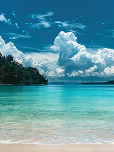 the ocean is blue and clear with white clouds