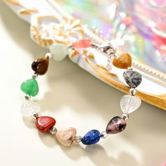 Experience elegance and playfulness with our Natural Stone Heart Beaded Bracelet! This bracelet showcases a stunning array of heart shaped natural stones, each one carefully selected for its unique hue and texture. Each colorful stone is handpicked to inspire unique beauty. Perfect for holidays and beach adventures in a hot summer day. Show your love for nature with this one of a kind piece! DETAILS Materials: Brass, Natural Stones Measurements: Length: 6.69"(17cm)+Extender: 1.57"(4cm) Weight: 1 Bohemian Crystal Bracelet With Heart Beads, Heart-shaped Beaded Crystal Bracelet For Jewelry Making, Bohemian Heart Beads Bracelet As Gift, Bohemian Heart-shaped Beaded Bracelets For Healing, Spiritual Heart-shaped Beaded Bracelets For Valentine's Day, Heart Shaped Beaded Bracelet With Gemstone Beads For Gift, Heart-shaped Beaded Bracelet With Gemstone Beads For Gift, Handmade Heart-shaped Healing Bracelets, Heart-shaped Gemstone Beads Bracelets For Gift