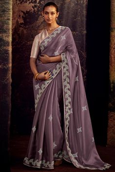 This beautiful Art Silk Saree is perfect for any fancy function. The intricate embroidery work adds a touch of elegance to the already dazzling fabric. Made from high-quality materials, this saree is both comfortable and durable. The saree comes with a contrast blouse piece that can be tailored to fit your unique body type. Whether it's a wedding or a formal event, you'll look stunning in this saree. Lavender Saree Contrast Blouse, Lavender Saree, Saree Contrast Blouse, Classic Saree, Dori Work, Blouse Designed, Wedding Sarees Online, Indian Wedding Saree, Partywear Sarees