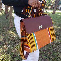 You ask, we went to work. HERE IT IS Y'ALL Our original Kente fabric bag will be perfect for your daily use. It comes with a handle and an adjustable crossbody strap for a comfortable use.  Details: -Handwoven Kente Ghana fabric -Velvet interior lining -2 pockets - Interior divider  -Adjustable crossbody strap   Dimensions 14 x 10 x 5.5 inches Yellow Woven Top Handle Shoulder Bag, Handwoven Top Handle Satchel, Artisan Bags With Weaving Work For Everyday Use, Artisan Shoulder Bag With Weaving Work For Everyday, Everyday Weaving Work Shoulder Bag, Artisan Yellow Bag For Everyday Use, Artisan Shoulder Bag With Weaving Work, Artisan Yellow Shoulder Bag For Daily Use, Yellow Artisan Bags For Daily Use