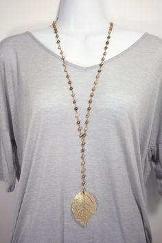 This lariat style necklace is perfect for the fall season. Easy to wear even over a sweater and no clasp to fiddle with. The top of the necklace measures 30 inches and the bottom portion is 6 inches. Each bead is wired with antique gold colored wire by hand, ending in a  highly detailed 14k gold dipped leaf. Adjustable Beaded Chain Lariat Necklace, Bohemian Lariat Necklace With Beaded Chain, Bohemian Beaded Lariat Necklace, Brown Lariat Necklace With Adjustable Length, Bohemian Lariat Single Strand Long Necklace, Handmade Adjustable Jewelry For Fall, Handmade Brown Lariat Necklace, Adjustable Handmade Jewelry For Fall, Gold Bohemian Lariat Necklace With Natural Stones