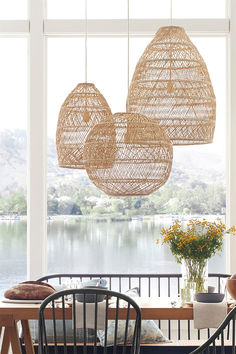 the dining room table and chairs are made out of wicker hanging from the ceiling