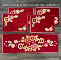 three red place mats with flowers on them