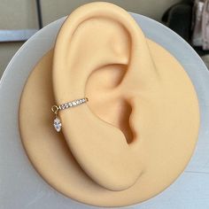 an ear shaped cake with a diamond ring on top