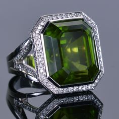 This 43.81 carat emerald cut Burmese peridot is a very rare gemstone, so of course we had to acquire it for our LXV Leo ring. It is handset set in 18k white gold and surrounded by almost two carats of diamonds. Leo Ring, Right Hand Rings, Hand Ring, Party Rings, Diamond Cocktail Rings, Rare Gemstones, Clear White, Halo Ring, Gorgeous Jewelry