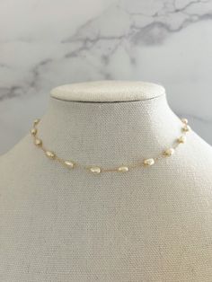 "Pearl Necklace - made from porcelain pearls, detailed on an 18k gold filled chain, and has an extender chain attached for different lengths.   This simple and dainty Pearl necklace is perfect for everyday wear- even into the night! Necklace length: 15 3/4\" with 2\" extender Porcelain Pearl Size: 4mm Material: 18k Gold Filled Chain" Minimalist Pearl Jewelry, Gold Single Strand Dainty Pearl Necklace, Gold Jewelry With Adjustable Chain And Baroque Pearl, Gold Bohemian Jewelry With Adjustable Baroque Pearl Chain, Delicate Gold Baroque Pearl Necklaces, Delicate Gold Single Strand Pearl Necklace, Gold Baroque Pearl Chain Necklace Gift, Gold Baroque Pearl Necklace With Delicate Chain, Yellow Gold Baroque Pearl Necklace With Adjustable Chain