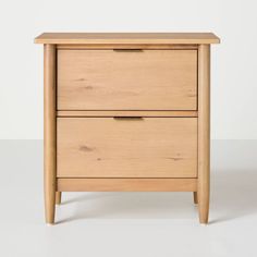 a wooden nightstand with two drawers on one side and an open drawer on the other