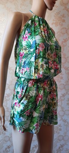 "Vintage halter neck playsuit in a green\\pink\\yellow floral design.  It has a high neck with a tie at the back of the neck,  aqn elastic waist and side pockets' Bust;   34\"  Waist;   28\" Length;   29\"       Made by Pimkie      polyester cotton" Summer Floral Print Mini Jumpsuits And Rompers, Summer Floral Print Mini Jumpsuit Or Romper, Floral Print Mini Jumpsuits And Rompers For Vacation, Summer Floral Print Mini Jumpsuit, Floral Print Mini-length Jumpsuits And Rompers For Vacation, Summer Floral Print Mini Romper, Summer Floral Mini Romper, Beach Floral Print Mini Shorts, Beach Mini Shorts With Floral Print