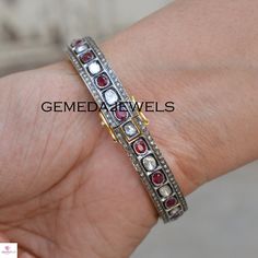 Polki Diamond Silver Bangle, Red Ruby Gemstone Bangle, 925 Sterling Silver Jewelry, Openable Bangle Bracelet, Wedding Gift, Gift For her Gross Weight: 29.59 gram Gemstone Weight: 8.91 cts Polki Diamond Weight: 1.52 cts Pave Diamond Weight: 2.44 cts Bangle Size: 63X63 MM NOTE:- All The Products Are Designed And Manufactured In My Workshop By Me & My Team. Shown Products Are Purely Handmade. Custom Orders Are Open Handly Accepted. We Are Perfect Choice For Any Custom Jewelry Manufacturing. For Fine Jewelry Anniversary Bracelet With Rose Cut Diamonds, Fine Jewelry Rose Cut Diamond Bracelet For Anniversary, Sterling Silver Cuff Bracelet With Gemstone For Wedding, Adjustable Ruby Bracelets For Formal Occasions, Adjustable Ruby Bracelet For Formal Occasions, Formal Adjustable Ruby Bracelets, Red Oval Diamond Bracelet As Gift, Red Oval Diamond Bracelet For Gift, Sterling Silver Diamond Gemstone Bracelet As A Gift