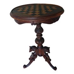 an old wooden table with a checkered top