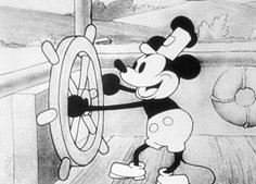 the mickey mouse character is trying to pull on a spinning wheel in front of him