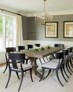 a dining room table with chairs and a chandelier