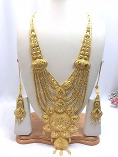 Handmade Indian Jewelry Asian Wedding Bridal Jewellery Party Ethnic Wear 22ct Gold Plated Bridal Necklace Set Rani Haar Bridal Jewellery Set  PLEASE NOTE, This Item Is Not Real Gold .Only Good Quality Gold Plated Jewellery .it is Artificial Jewellery.  It is a perfect match with formal attire on special occasions or with casual wearing.  Slight Colour variations possible due to difference in screen and photograph Care instructions Keep Jewellery away from direct heat, water, perfumes, deodorants Chandbali-shaped Yellow Gold Bridal Necklace For Puja, Yellow Gold Chandbali Bridal Necklace For Puja, 22k Gold Jewelry With Zari Work, Festive Gold-plated Tikka, Traditional Wear With Intricate Design In Gold, Gold Kundan Necklace With Cutdana For Eid, Gold Jewelry Sets With Tilla For Festivals, 22k Gold Jewelry Sets For Puja And Festive Occasions, Gold Temple Necklace With Zari Work For Wedding