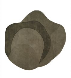 three round rugs in various shades of grey and brown, on a white background