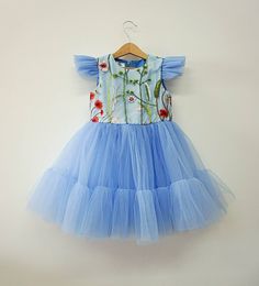 Perfect pale blue tulle dress for toddlers for celebrating wedding, first birthday and many other events. --- -Description- Material - soft dusty blue tulle Sleeve - short butterfly sleeves Lining - soft 100% cotton lining Length - knee length --- Sizes available: 6-9 months 9-12 months 12-18 months 1T 2T 3T 4T 5T Please, feel free to contact me if you have any questions. Flutter Sleeve Tulle Dress With Ruffles, Tulle Dresses With Ruffles And Flutter Sleeves, Tulle Dress With Ruffles And Flutter Sleeves, Light Blue Tutu Dress For Summer Dress-up, Garden Party Tulle Princess Dress With Floral Applique, Garden Party Princess Dress With Floral Applique, Summer Princess Dress With Floral Applique In Tulle, Summer Princess Dress With Floral Applique, Short Sleeve Tulle Dress With Floral Applique