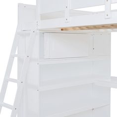 there is a white bunk bed with ladders on the top and bottom part of it