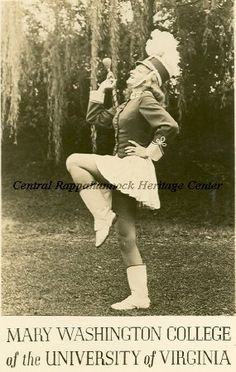 an old black and white photo of a woman doing a dance pose in front of trees