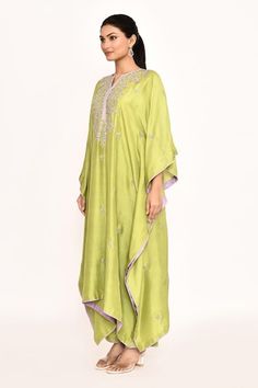 Green kaftan featuring zardozi embroidered floral patterns and a notched neckline. Paired with matching solid pants for a complete look., Fit: Relaxed Anarkali Kaftan With Embroidered Border For Eid, Diwali Embroidered Kaftan With Traditional Drape, Designer Purple Kurta With Embroidered Border, Designer Purple Embroidered Kurta, Festive Silk Purple Kaftan, Festive Purple Silk Kaftan, Purple Kurta With Embroidered Border For Eid, Green Embroidered Kaftan For Eid, Green Kaftan