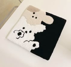 a black and white rug with a dog on it's side next to a toilet