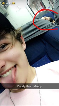 a man sticking his tongue out while on an airplane with the caption daddy heath sleepy