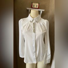 Menghui Fashion Crystal Jewelry Rhinestone Lapel Button Down Shirt White Blouse Women’s Size S. Tag L, But Fits Size S. Brand New With Original Tag. Price Is Firm. Nice For Holiday Pictures. Nice Shape . Measurements (Approximate While Lying Flat - See Attached Photos). Please Double Check The Measurements As There Are No Returns. No Holds. Smoke Free Home. Please See My Pictures For Details As They Are Part Of My Description. Thank You For Looking. Elegant Button-up Embellished Blouse, Elegant Embellished Button-up Blouse, Elegant Embellished Workwear Shirt, Embellished Button-up Workwear Blouse, Embellished Fitted Shirt For Workwear, Elegant Embellished Spring Shirt, Elegant Long Sleeve Shirt With Rhinestones, Embellished Long Sleeve Shirt For Formal Occasions, Elegant Workwear Blouse With Pearl Buttons