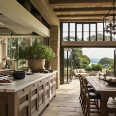 an open kitchen and dining room with large windows