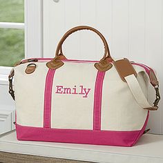 a pink and white duffel bag sitting on top of a counter next to a window