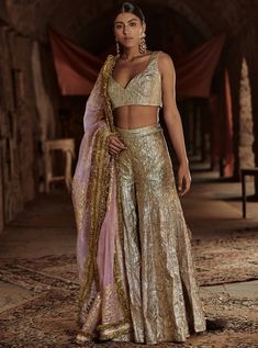 This set features a Full lampi gold sharara and textured lampi blouse teamed up with dupatta which is beautifully embellished with gota patti and hand embroidered with zari edged with fine kiran. F... Gold Sharara, Desi Attire, Gold Lehenga, Sharara Designs, Saree Style, Traditional Indian Outfits, Sharara Set, Indian Wedding Outfits, Indian Fashion Designers