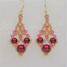 pink and gold earrings with beads on them