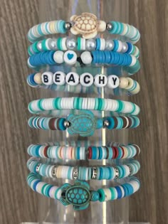 a stack of bracelets with the words beachy on them