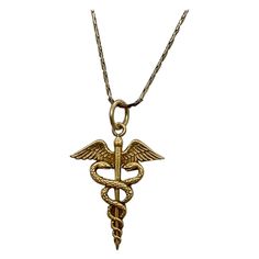 INDULGE IN A WONDERFUL CADUCEUS PENDANT WITH ENTWINED SNAKES IN 10 KARAT YELLOW GOLD. The caduceus is a symbol that features two snakes wrapped around a staff, often with wings, and is associated with medicine, Hermes, and peaceful dispute resolution. THE CADUCEUS IS OFTEN USED AS A SYMBOL FOR MEDICINE AND IS A WONDERFUL JEWEL FOR THE DOCTOR, NURSE, PA, MD, PHYSICIAN, AS WELL AS LOVERS OF GREEK MYTHOLOGY, AND PEACE AS WELL AS HERMES AND MERCURY, AND LOVERS OF SNAKE JEWELRY. And snake jewelry is all the rage - look at the photo of Naomi Watts from the Oscars I have included! The caduceus is the staff carried by Hermes in Greek mythology. It is a short staff entwined by two serpents, sometimes surmounted by wings. In Roman iconography, it was often depicted being carried in the left hand of Hermes Staff, Greek Necklace, Two Snakes, Victorian Pendant Necklace, Greek Mythology Jewelry, Dispute Resolution, Victorian Pendants, Medicine Doctor, Music Jewelry