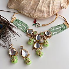 Green kundan necklace set with earrings. Bollywood Kundan Necklace With Zari Work For Party, Green Kundan Necklace For Party, Party Kundan Necklace With Zari Work In Chandbali Shape, Party Kundan Chandbali Necklace With Zari Work, Kundan Chandbali Necklace With Zari Work For Party, Chandbali Kundan Necklace With Zari Work For Party, Diwali Party Kundan Cutdana Necklace, Party Kundan Necklaces With Zari Work, Party Kundan Necklace With Zari Work