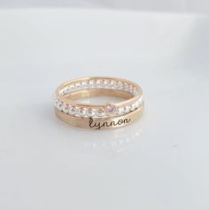 Valentine's Day Gift | -the Isabelle- Personalized stackable ring set, engraved with a name, date, or special word.  Metal: .925 sterling silver, and 14k gold filled Dimensions: name ring is 2mm tall on average, but our rings are handmade so variations will occur. Birthstone is 2mm on a 1mm band. connect with us: http://instagram.com/shopgoinggolden http://www.facebook.com/shopgoinggolden http://tiktok.com/@shopgoinggolden Mom Rings, Personalized Stackable Rings, Rings Personalized, Stackable Ring Sets, Birthstone Rings, Mom Ring, Name Ring, Name Rings, Special Words