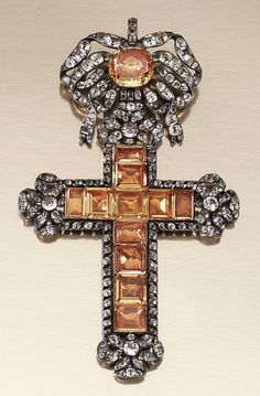 PASTE PENDANT, PORTUGUESE LATE 18TH CENTURY. Designed as a Latin cross, suspended from a tied ribbon bow surmount, similarly decorated to the cardinal points, set with foil backed table-cut and cushion-shaped paste of yellow tint, highlighted with circular-shaped near-colourless paste. 17th Century Jewelry, White Gold Diamond-cut Crucifix Jewelry, 18th Century Jewelry, Luxury Byzantine Crucifix Jewelry, Diamond-cut Crucifix Necklace, Antique Collectible Crucifix Jewelry, Sign Of The Cross, Georgian Jewelry