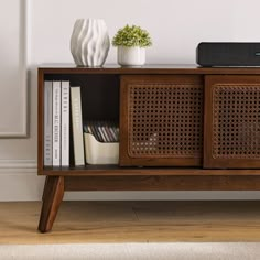 an entertainment center with books and speakers on it