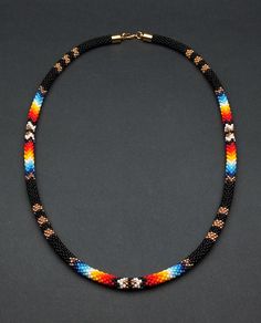 Add a touch of cultural flair with this ethnic beaded choker necklace. Inspired by Native American traditions, the intricate beadwork and unique design make it a standout piece of jewelry. Beaded Necklace Native, Native American Beadwork Earrings, Native Necklace, Crochet Beaded Necklace, Native American Beadwork Patterns, Beaded Jewelry Earrings, Jewelry Knowledge, Native American Bracelets, Beaded Necklace Patterns