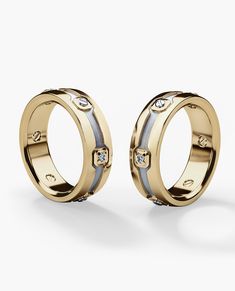 two gold rings with diamonds on them