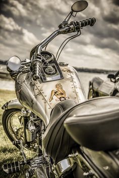 a motorcycle parked on top of a lush green field