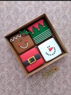 an open box filled with assorted decorated cookies