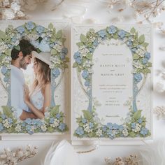 two wedding cards with blue and white flowers on them, one has a photo of the bride and groom